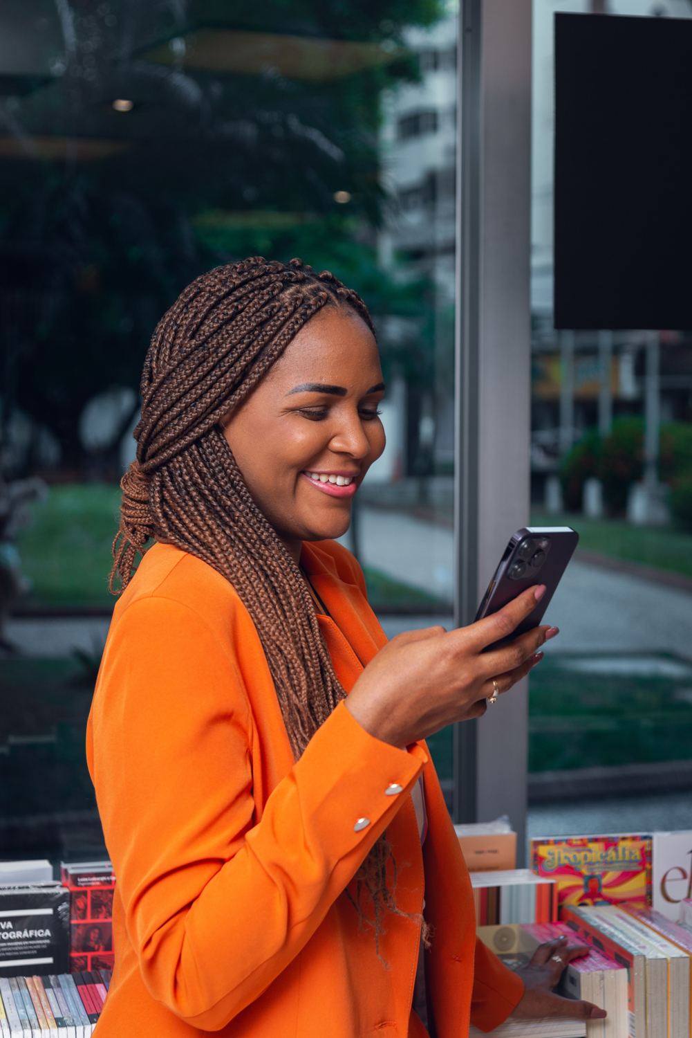 A woman smiling at her phone